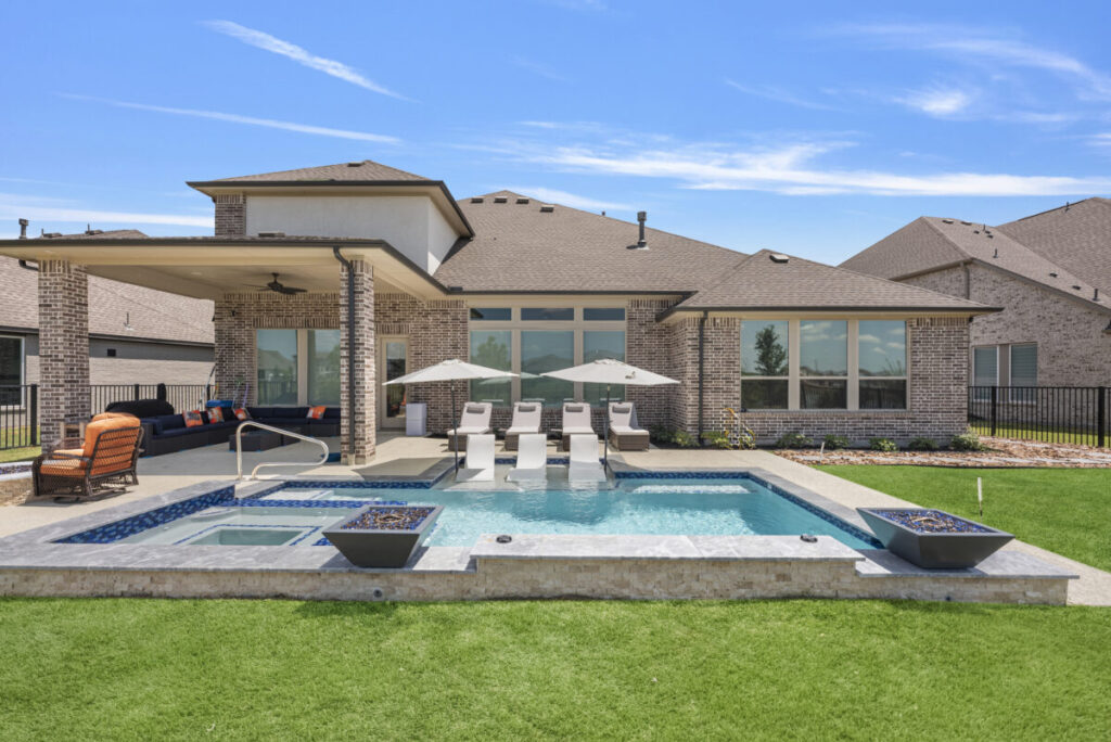 Cypress Project - Blue Wood - Geometric pool, tanning ledge, spa, safety railing, raised back wall, two fire bowls, one scupper, gas fire pit, multi-colored glass beads, travertine topper, split-face siding, glass tile, Arizona Sugar spray decking