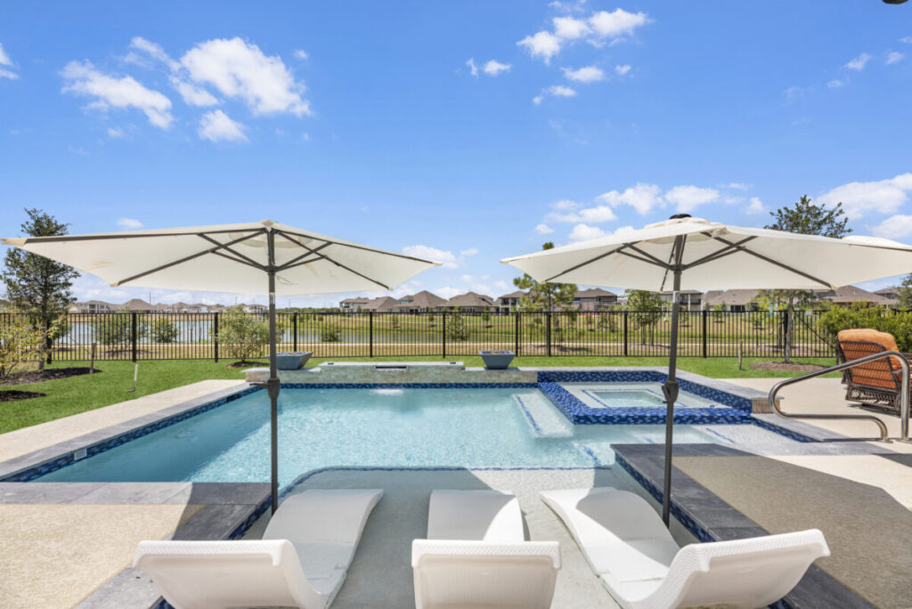 Cypress Project - Blue Wood - Geometric pool, tanning ledge, spa, safety railing, raised back wall, two fire bowls, one scupper, gas fire pit, multi-colored glass beads, travertine topper, split-face siding, glass tile, Arizona Sugar spray decking