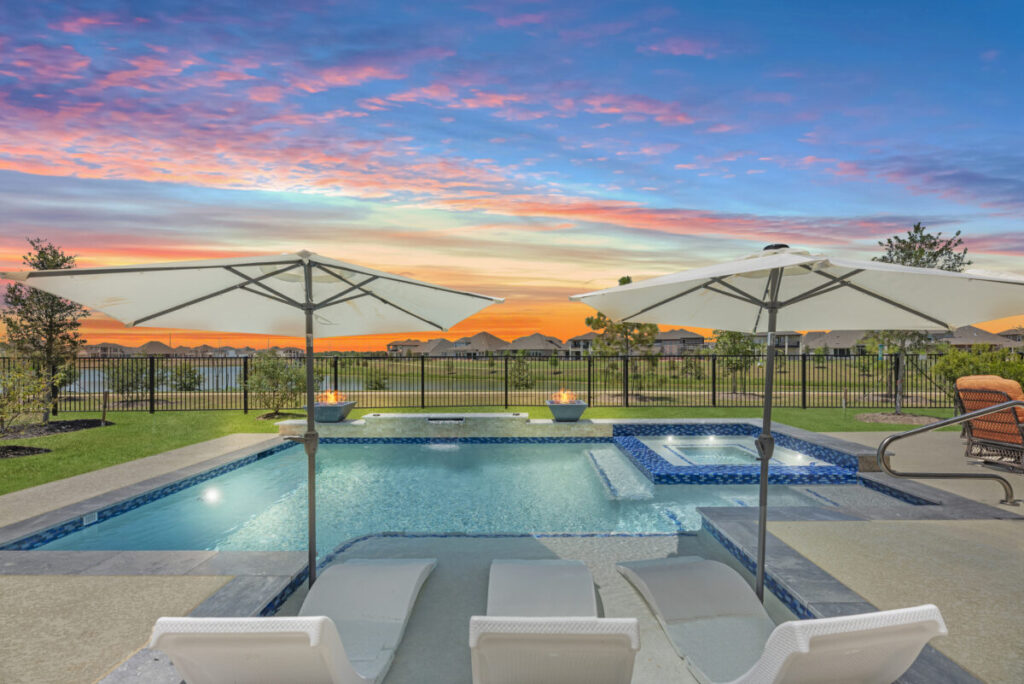 Cypress Project - Blue Wood - Geometric pool, tanning ledge, spa, safety railing, raised back wall, two fire bowls, one scupper, gas fire pit, multi-colored glass beads, travertine topper, split-face siding, glass tile, Arizona Sugar spray decking
