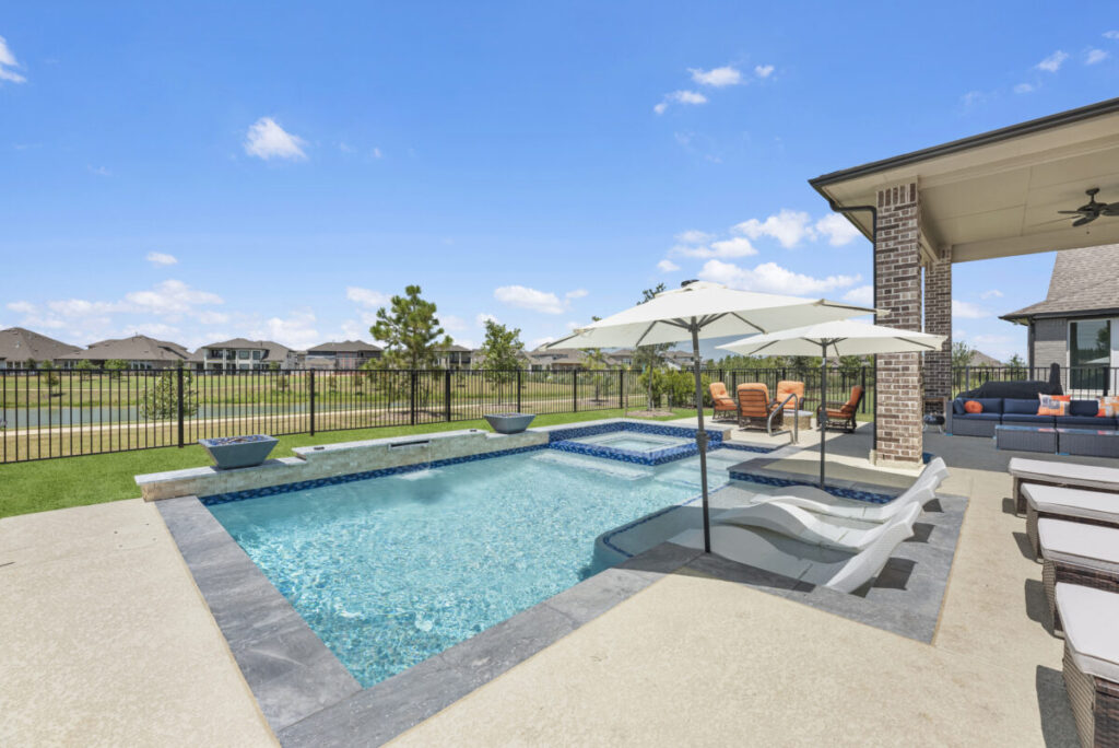 Cypress Project - Blue Wood - Geometric pool, tanning ledge, spa, safety railing, raised back wall, two fire bowls, one scupper, gas fire pit, multi-colored glass beads, travertine topper, split-face siding, glass tile, Arizona Sugar spray decking