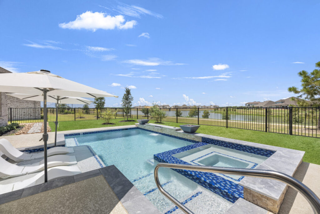 Cypress Project - Blue Wood - Geometric pool, tanning ledge, spa, safety railing, raised back wall, two fire bowls, one scupper, gas fire pit, multi-colored glass beads, travertine topper, split-face siding, glass tile, Arizona Sugar spray decking