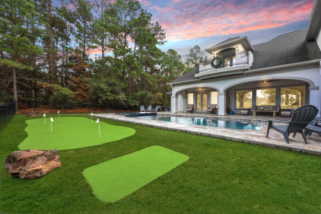 Magnolia Ranch Project - Roman-style pool with infinity edge spa, pillow-top edge, water features – three bubblers, six deck jets, French pattern travertine decking, chipping mat, artificial turf with putting green, accent boulders
