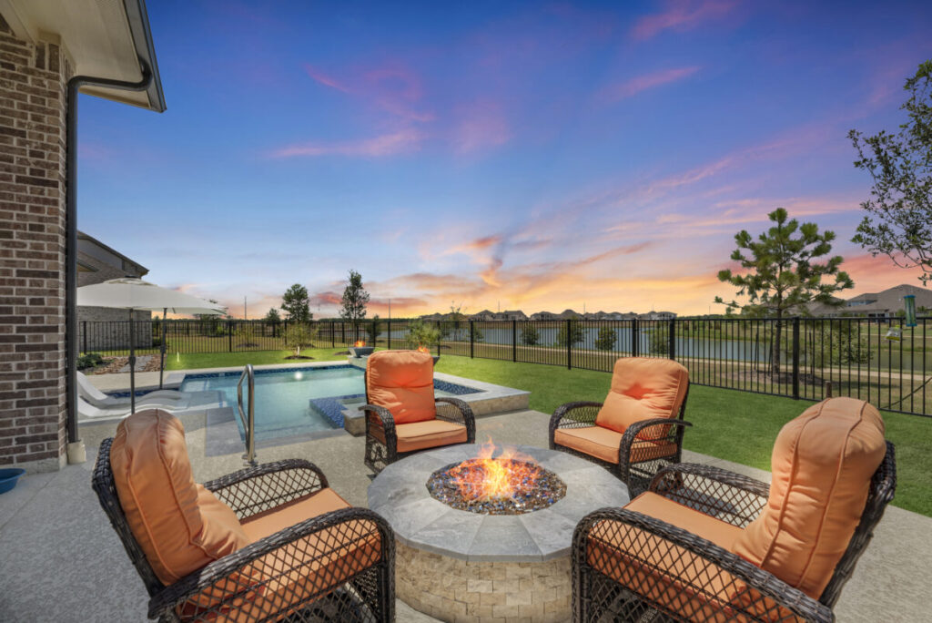 Cypress Project - Blue Wood - Geometric pool, tanning ledge, spa, safety railing, raised back wall, two fire bowls, one scupper, gas fire pit, multi-colored glass beads, travertine topper, split-face siding, glass tile, Arizona Sugar spray decking