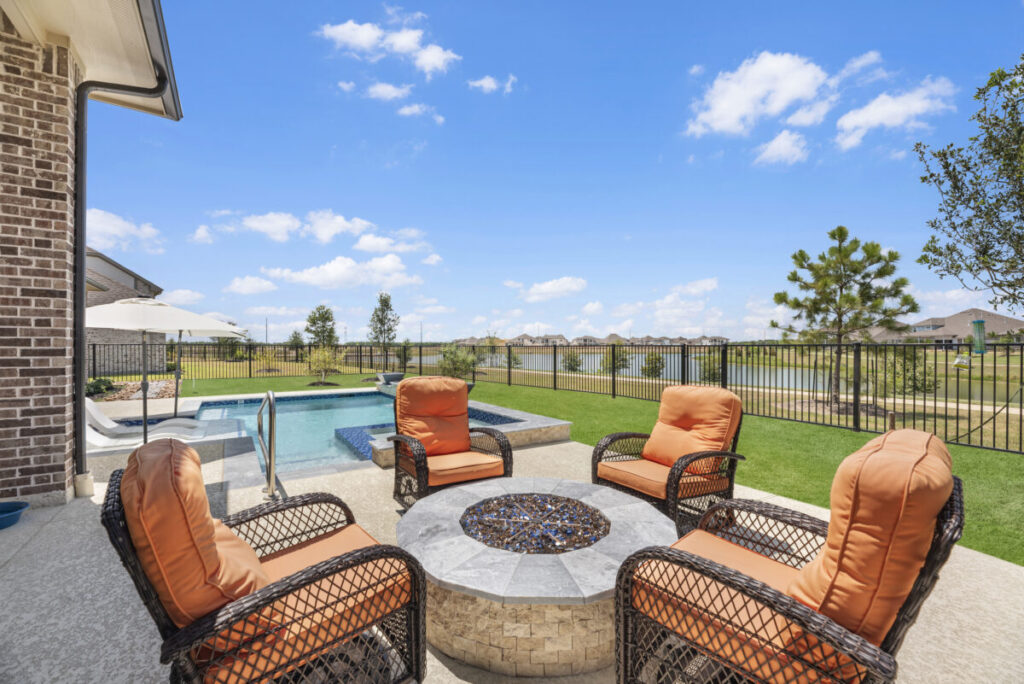 Cypress Project - Blue Wood - Geometric pool, tanning ledge, spa, safety railing, raised back wall, two fire bowls, one scupper, gas fire pit, multi-colored glass beads, travertine topper, split-face siding, glass tile, Arizona Sugar spray decking