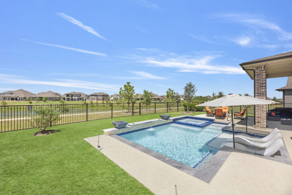 Cypress Project - Blue Wood - Geometric pool, tanning ledge, spa, safety railing, raised back wall, two fire bowls, one scupper, gas fire pit, multi-colored glass beads, travertine topper, split-face siding, glass tile, Arizona Sugar spray decking