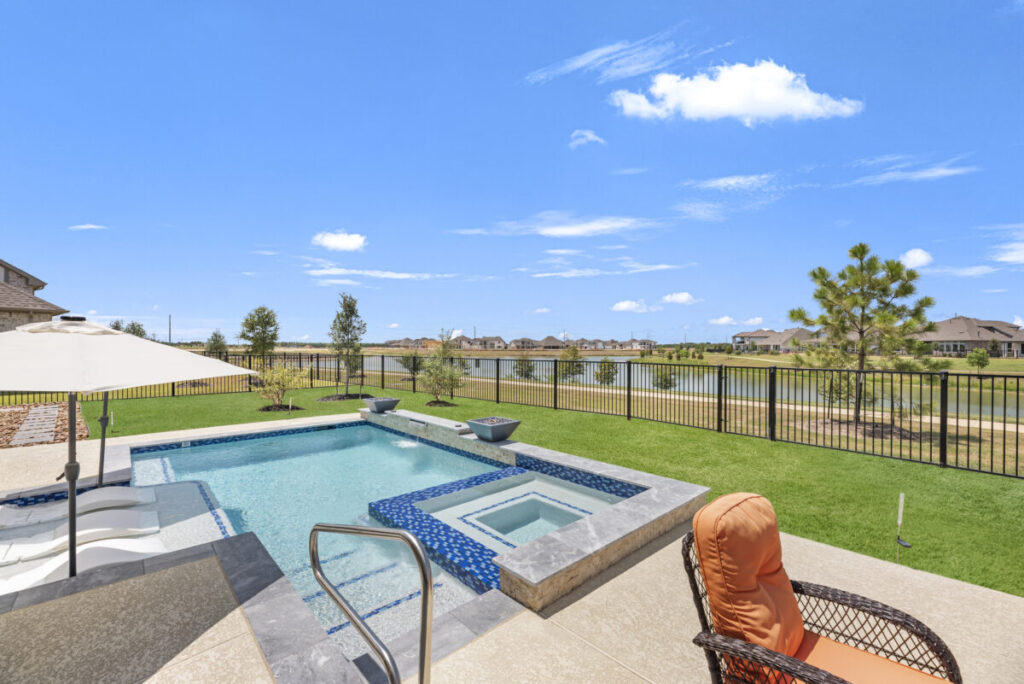 Cypress Project - Blue Wood - Geometric pool, tanning ledge, spa, safety railing, raised back wall, two fire bowls, one scupper, gas fire pit, multi-colored glass beads, travertine topper, split-face siding, glass tile, Arizona Sugar spray decking