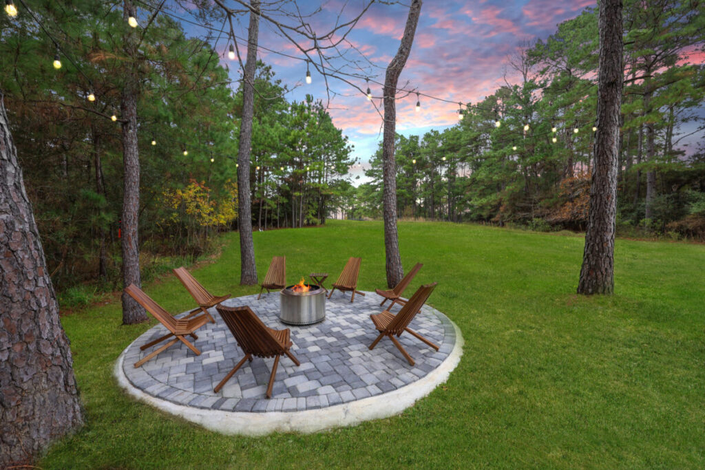 Magnolia Ranch Project - Roman-style pool with infinity edge spa, pillow-top edge, water features – three bubblers, six deck jets, French pattern travertine decking, chipping mat, artificial turf with putting green, accent boulders