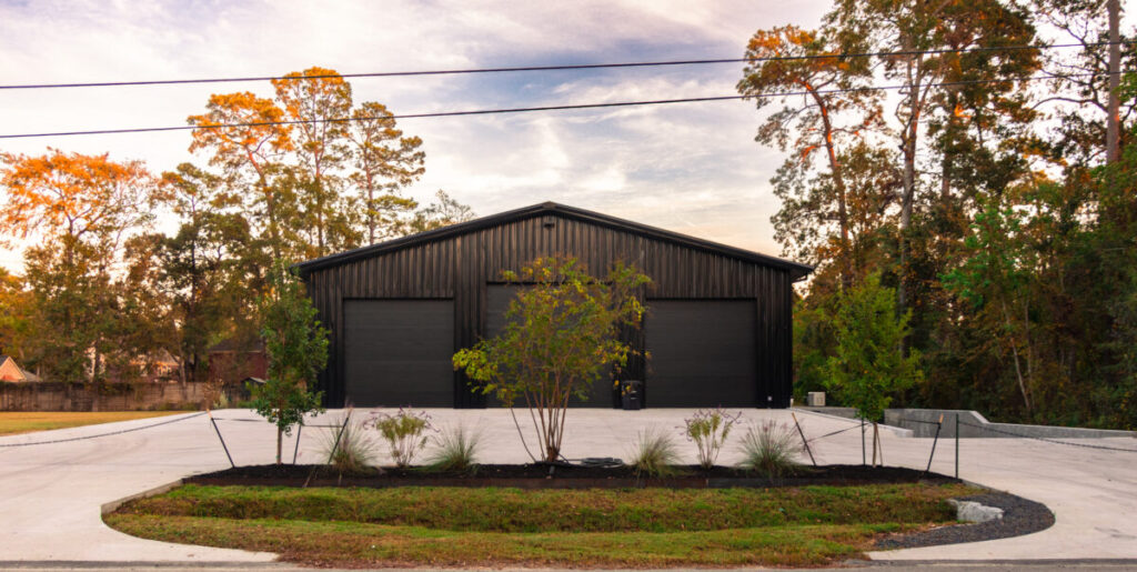 Houston Project - Acorn Ln - hardscaping, poured-in-place concrete pavers, black star gravel walkway, raised metal borders, artificial turf, low maintenance plants
