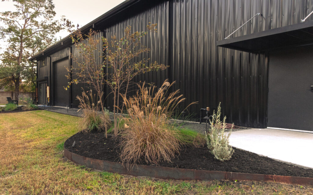 Houston Project - Acorn Ln - hardscaping, poured-in-place concrete pavers, black star gravel walkway, raised metal borders, artificial turf, low maintenance plants