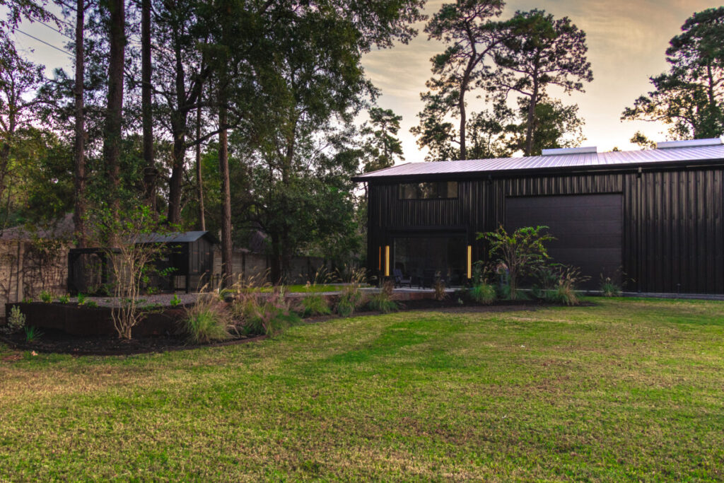 Houston Project - Acorn Ln - hardscaping, poured-in-place concrete pavers, black star gravel walkway, raised metal borders, artificial turf, low maintenance plants