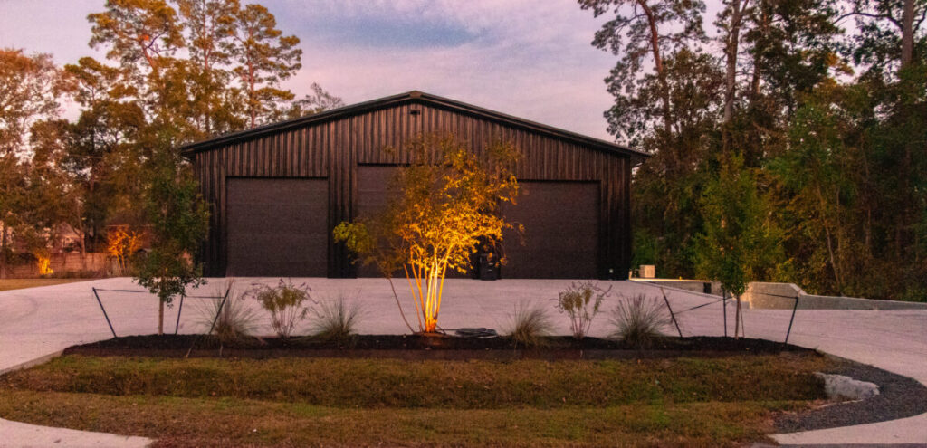Houston Project - Acorn Ln - hardscaping, poured-in-place concrete pavers, black star gravel walkway, raised metal borders, artificial turf, low maintenance plants