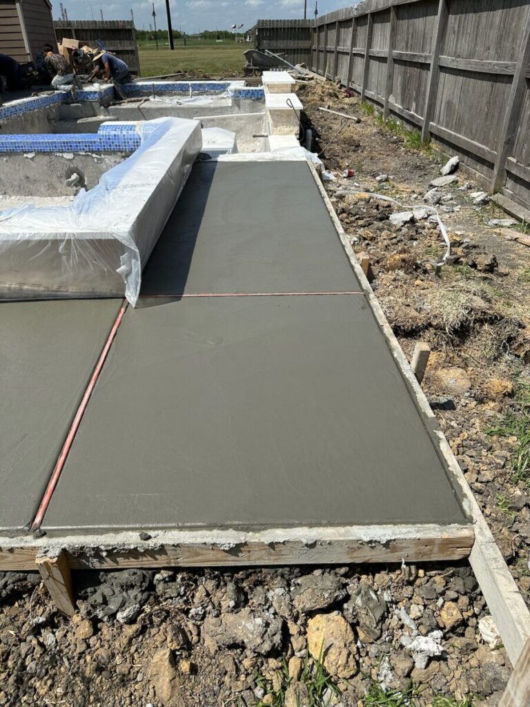 Mont Belvieu - Champions Gate - Geometric pool, raised spa, tanning ledge, water features - three scuppers and two bubblers, travertine coping, glass tile, pool table with travertine topper, raised backwall, spray decking, StoneScapes plaster