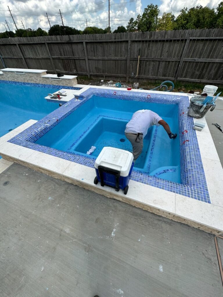 Mont Belvieu - Champions Gate - Geometric pool, raised spa, tanning ledge, water features - three scuppers and two bubblers, travertine coping, glass tile, pool table with travertine topper, raised backwall, spray decking, StoneScapes plaster