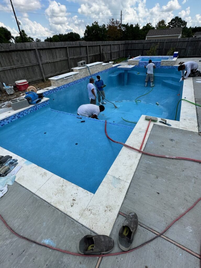 Mont Belvieu - Champions Gate - Geometric pool, raised spa, tanning ledge, water features - three scuppers and two bubblers, travertine coping, glass tile, pool table with travertine topper, raised backwall, spray decking, StoneScapes plaster