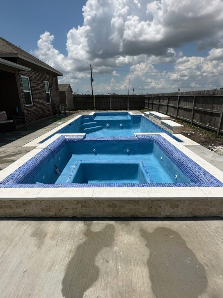 Mont Belvieu - Champions Gate - Geometric pool, raised spa, tanning ledge, water features - three scuppers and two bubblers, travertine coping, glass tile, pool table with travertine topper, raised backwall, spray decking, StoneScapes plaster