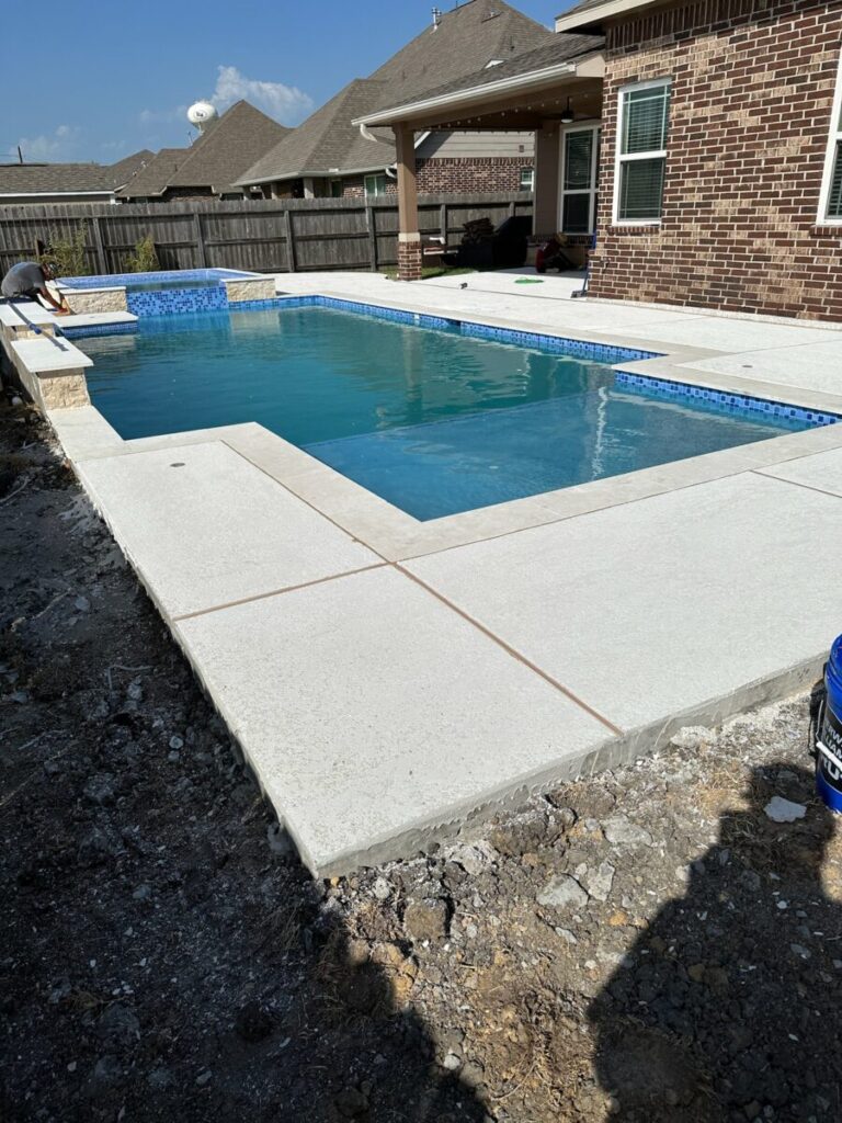 Mont Belvieu - Champions Gate - Geometric pool, raised spa, tanning ledge, water features - three scuppers and two bubblers, travertine coping, glass tile, pool table with travertine topper, raised backwall, spray decking, StoneScapes plaster