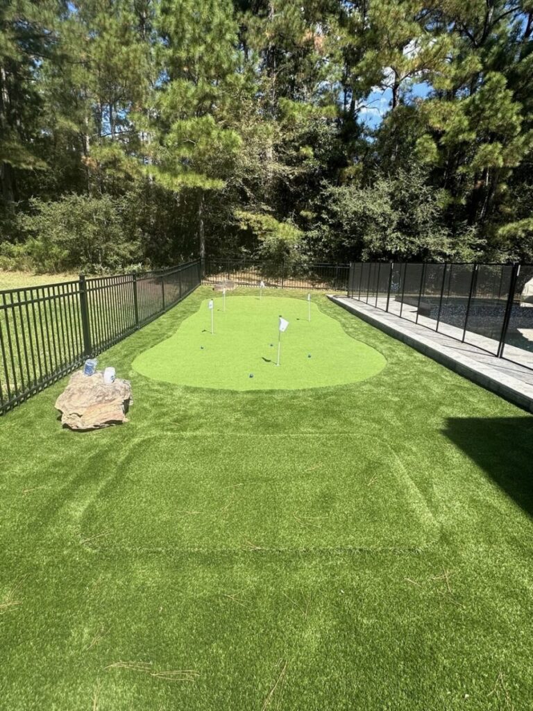 Magnolia Ranch Project - Roman-style pool with infinity edge spa, pillow-top edge, water features – three bubblers, six deck jets, French pattern travertine decking, chipping mat, artificial turf with putting green, accent boulders