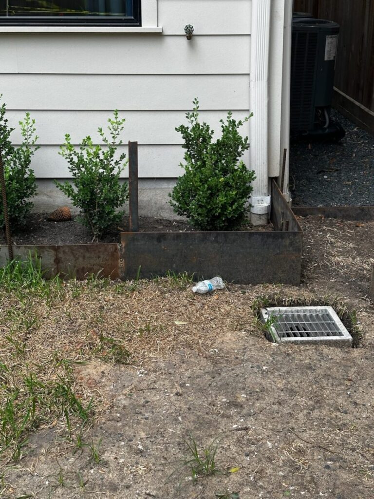 Heights Project Banks St - Poured-in-place concrete pavers, hardscaping, landscaping, Little Gem magnolia,, bamboo 'Graceful', Japanese yew, flax lily, black star gravel, white gravel, landscape uplights, Mexican heather, variegated liriope, sweet alyssum, metal planter, seasonal flowers, metal border built in-house, welded on-site, elegant white precast firepit