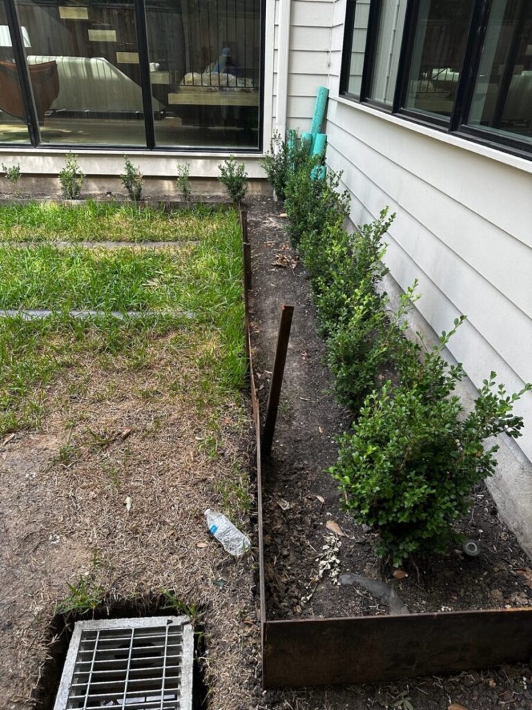 Heights Project Banks St - Poured-in-place concrete pavers, hardscaping, landscaping, Little Gem magnolia,, bamboo 'Graceful', Japanese yew, flax lily, black star gravel, white gravel, landscape uplights, Mexican heather, variegated liriope, sweet alyssum, metal planter, seasonal flowers, metal border built in-house, welded on-site, elegant white precast firepit