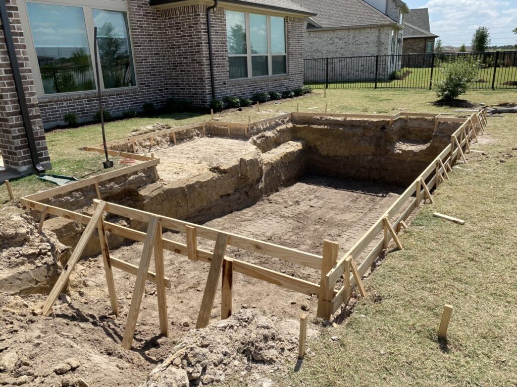 Cypress Project - Blue Wood - Geometric pool, tanning ledge, spa, safety railing, raised back wall, two fire bowls, one scupper, gas fire pit, multi-colored glass beads, travertine topper, split-face siding, glass tile, Arizona Sugar spray decking