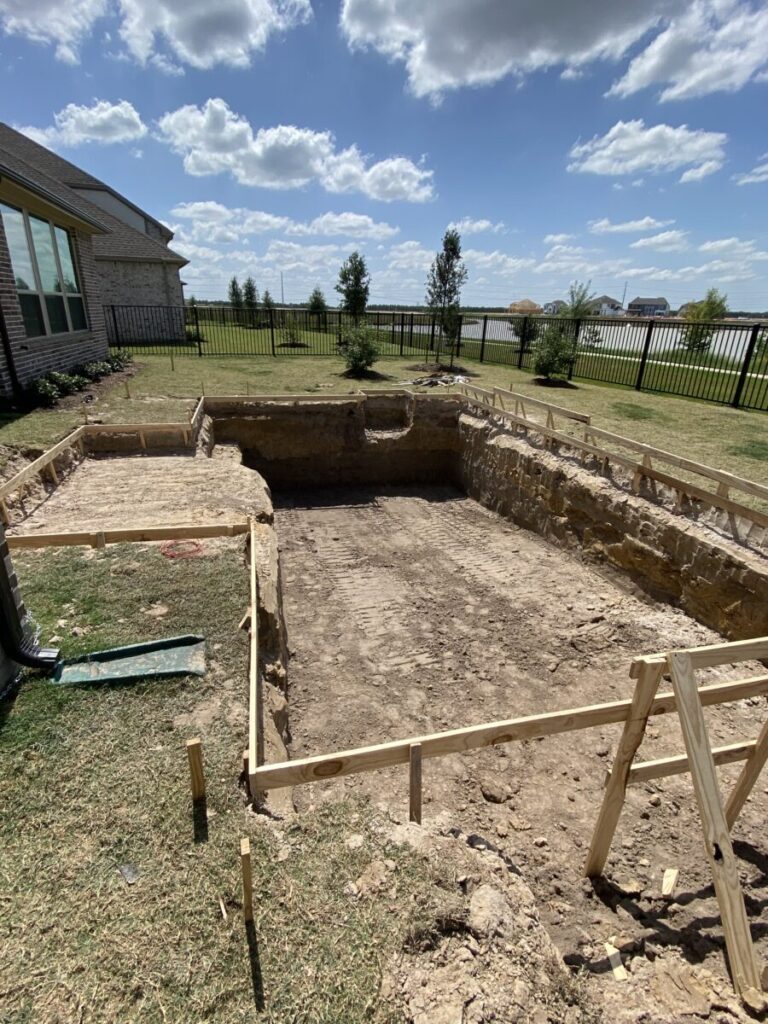 Cypress Project - Blue Wood - Geometric pool, tanning ledge, spa, safety railing, raised back wall, two fire bowls, one scupper, gas fire pit, multi-colored glass beads, travertine topper, split-face siding, glass tile, Arizona Sugar spray decking
