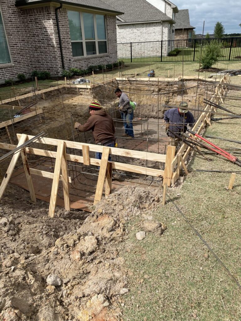Cypress Project - Blue Wood - Geometric pool, tanning ledge, spa, safety railing, raised back wall, two fire bowls, one scupper, gas fire pit, multi-colored glass beads, travertine topper, split-face siding, glass tile, Arizona Sugar spray decking