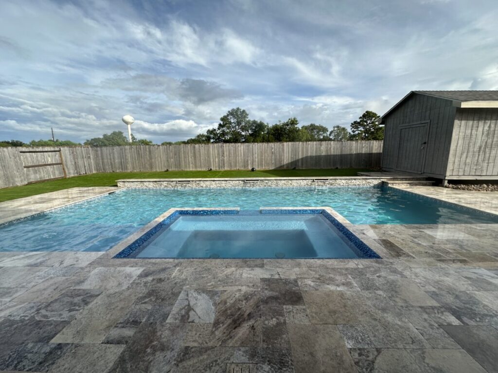 Cypress Project - Blue Wood - Geometric pool, tanning ledge, spa, safety railing, raised back wall, two fire bowls, one scupper, gas fire pit, multi-colored glass beads, travertine topper, split-face siding, glass tile, Arizona Sugar spray decking