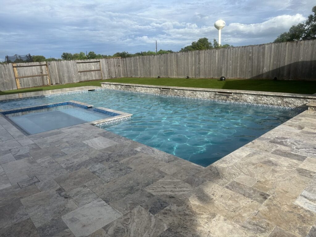 Cypress Project - Blue Wood - Geometric pool, tanning ledge, spa, safety railing, raised back wall, two fire bowls, one scupper, gas fire pit, multi-colored glass beads, travertine topper, split-face siding, glass tile, Arizona Sugar spray decking