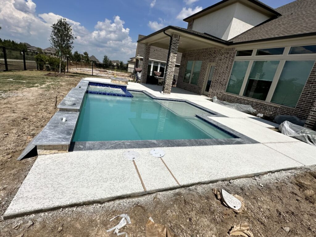 Cypress Project - Blue Wood - Geometric pool, tanning ledge, spa, safety railing, raised back wall, two fire bowls, one scupper, gas fire pit, multi-colored glass beads, travertine topper, split-face siding, glass tile, Arizona Sugar spray decking
