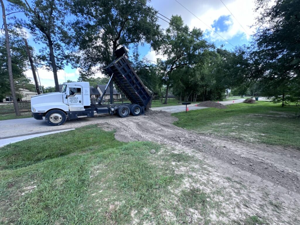 Houston Project - Acorn Ln - hardscaping, poured-in-place concrete pavers, black star gravel walkway, raised metal borders, artificial turf, low maintenance plants