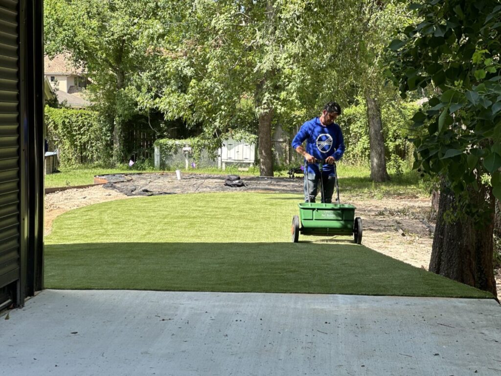 Houston Project - Acorn Ln - hardscaping, poured-in-place concrete pavers, black star gravel walkway, raised metal borders, artificial turf, low maintenance plants
