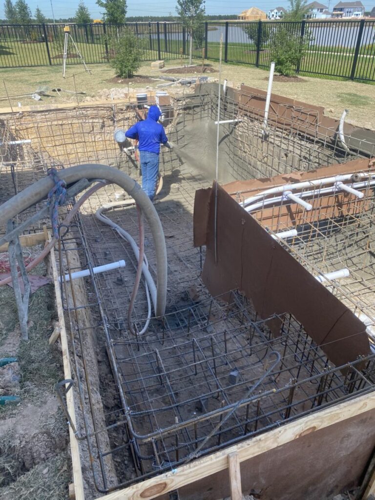 Cypress Project - Blue Wood - Geometric pool, tanning ledge, spa, safety railing, raised back wall, two fire bowls, one scupper, gas fire pit, multi-colored glass beads, travertine topper, split-face siding, glass tile, Arizona Sugar spray decking