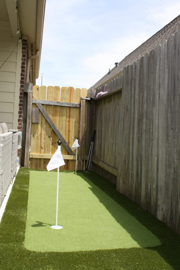 Texas Turf Tenders installed a geometric pool with a beach entry, tanning ledge, and in-water barstools. They added a raised spa with a rolled edge, a raised wall with columns and scuppers, plus surrounding turf and spray decking.