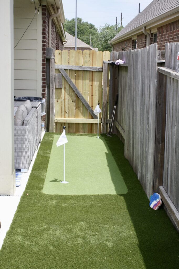 Texas Turf Tenders installed a geometric pool with a beach entry, tanning ledge, and in-water barstools. They added a raised spa with a rolled edge, a raised wall with columns and scuppers, plus surrounding turf and spray decking.