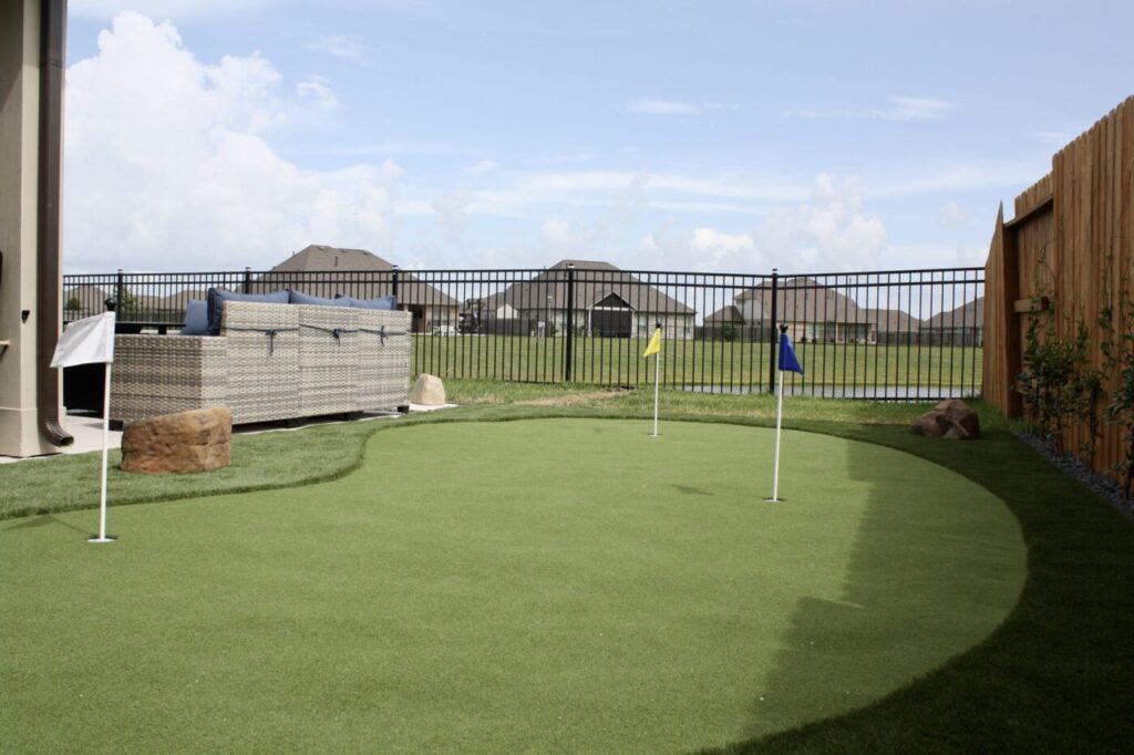 Texas Turf Tenders installed a geometric lap pool with a clean 6×6 tile finish. Spray decking offers a safe, polished surface, while a custom turf putting green adds a playful and personal touch.