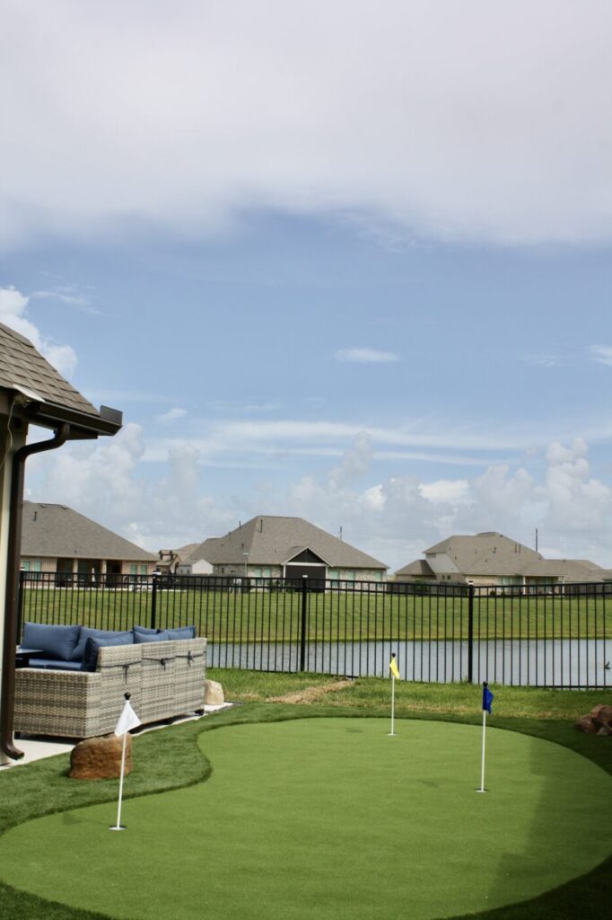 Texas Turf Tenders installed a geometric lap pool with a clean 6×6 tile finish. Spray decking offers a safe, polished surface, while a custom turf putting green finishes the minimal backyard makeover.