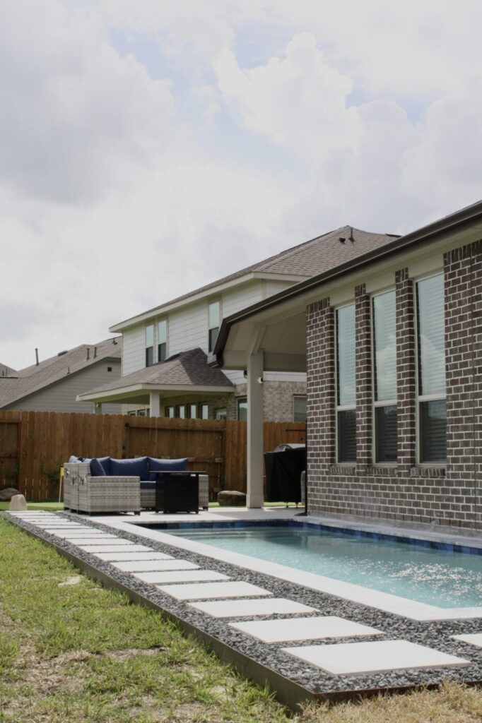 Texas Turf Tenders installed a geometric lap pool with a clean 6×6 tile finish. Spray decking offers a safe, polished surface, while a custom turf putting green finishes the minimal backyard makeover.