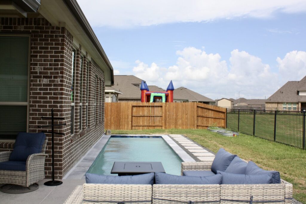 Texas Turf Tenders installed a geometric lap pool with a clean 6×6 tile finish. Spray decking offers a safe, polished surface, while a custom turf putting green finishes the minimal backyard makeover.